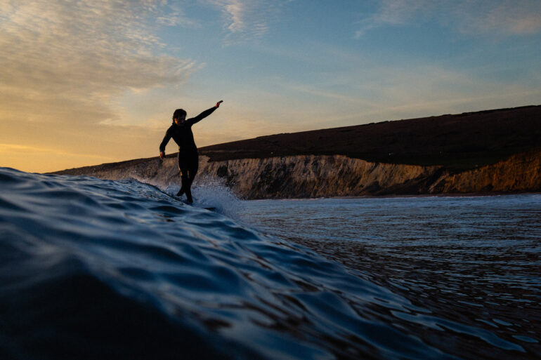 Colour photo of someone surfing in the sea off the Isle of Wight