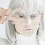 woman with silver hair, skin painted silver and silver clothes