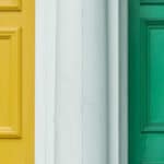 A yellow front door and a green front door