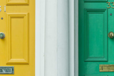 A yellow front door and a green front door