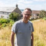 Hugh Fearnley Whittingstall standing in a field