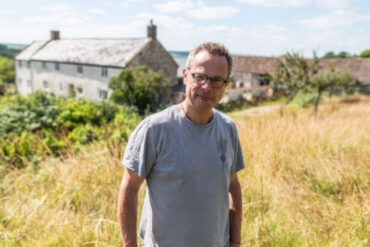 Hugh Fearnley Whittingstall standing in a field