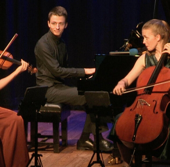 Amelio Trio playing instruments on stage