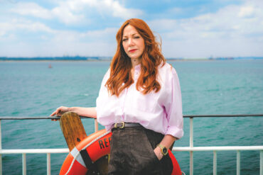 Diane Morgan standing on a red funnel ferry