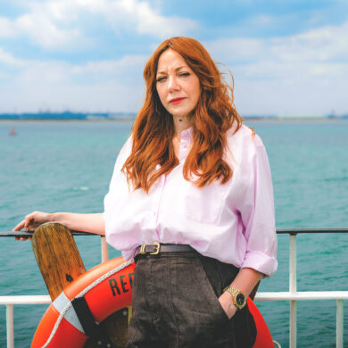 Diane Morgan standing on a red funnel ferry