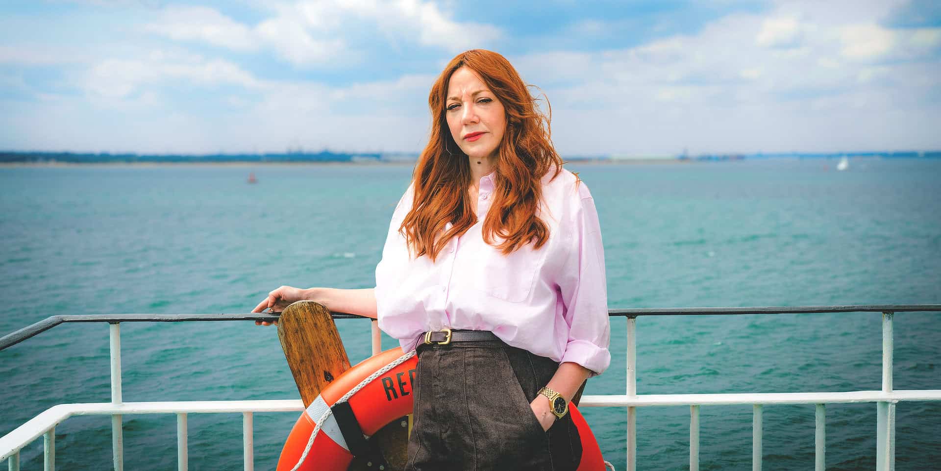 Diane Morgan standing on a red funnel ferry