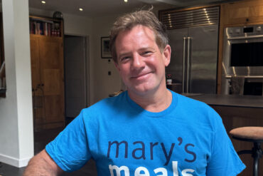 TV Chef Matt Tebbutt is showing his support for school feeding charity by wearing the T-shirt and drinking from a Mary's Meals mug