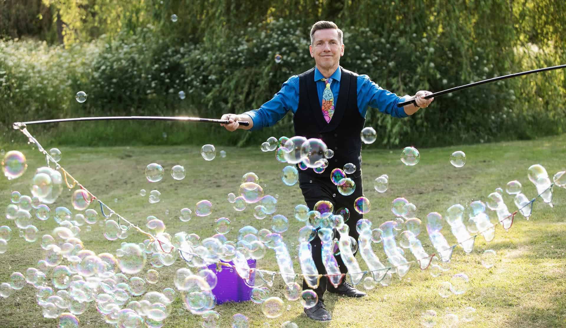 Lovely bubbly entertainer holding large rodas with lots of bubbles