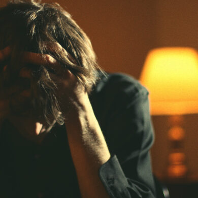 Man with head in hands looking frustrated