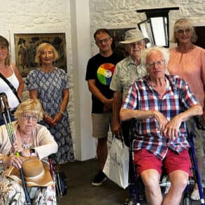 People posing for photograph in a gallery space