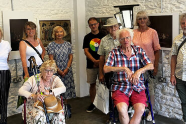 People posing for photograph in a gallery space