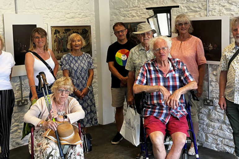 People posing for photograph in a gallery space