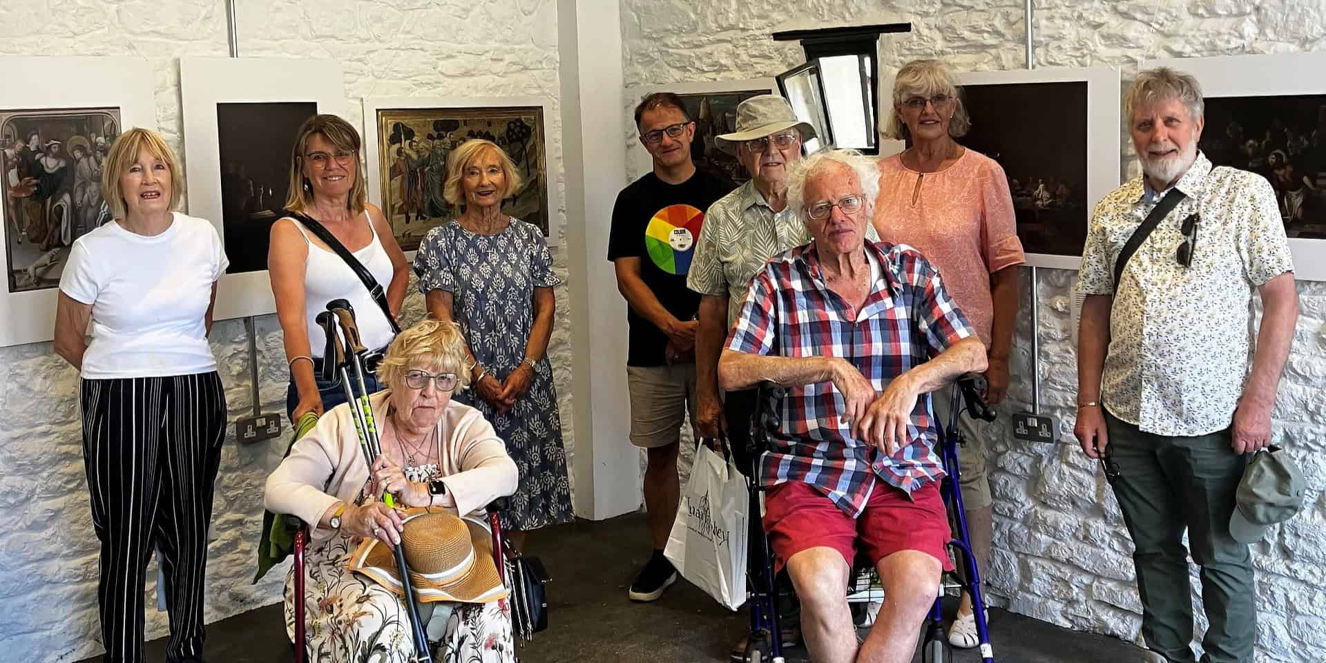 People posing for photograph in a gallery space