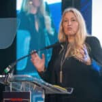 Sacha Dench standing at the podium delivering a talk