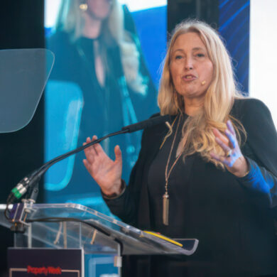Sacha Dench standing at the podium delivering a talk