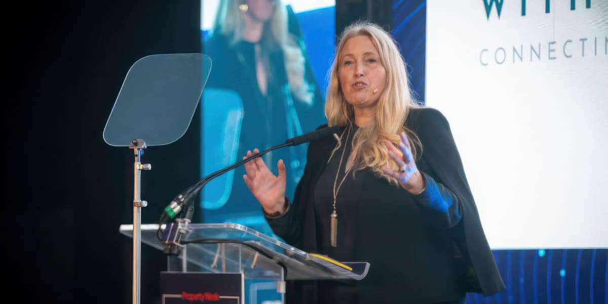 Sacha Dench standing at the podium delivering a talk