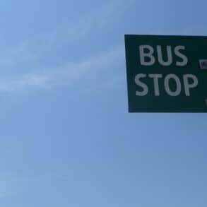bus stop sign against blue sky