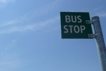 bus stop sign against blue sky