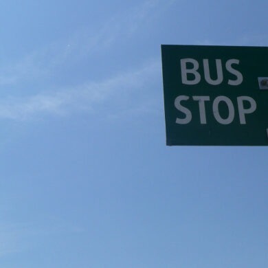 bus stop sign against blue sky