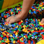 Person walking on bed of lego bricks