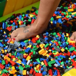 Person walking on bed of lego bricks
