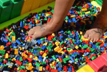 Person walking on bed of lego bricks