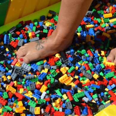 Person walking on bed of lego bricks