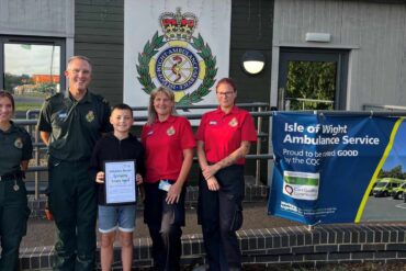 Oscar with ambulance staff and call handlers