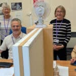 People standing by the desks at the information centre