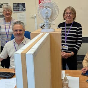 People standing by the desks at the information centre