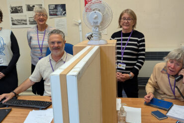 People standing by the desks at the information centre