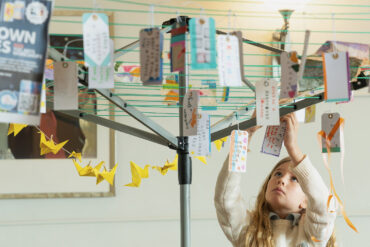 Messages of support for Sandown written on luggage labels hanging on a washing line