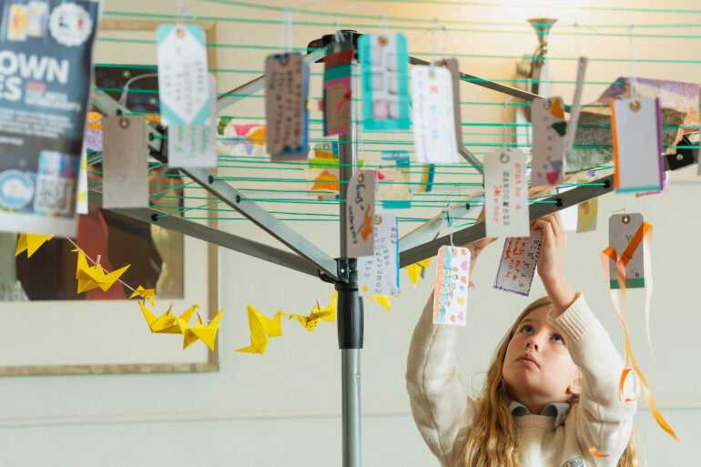 Messages of support for Sandown written on luggage labels hanging on a washing line