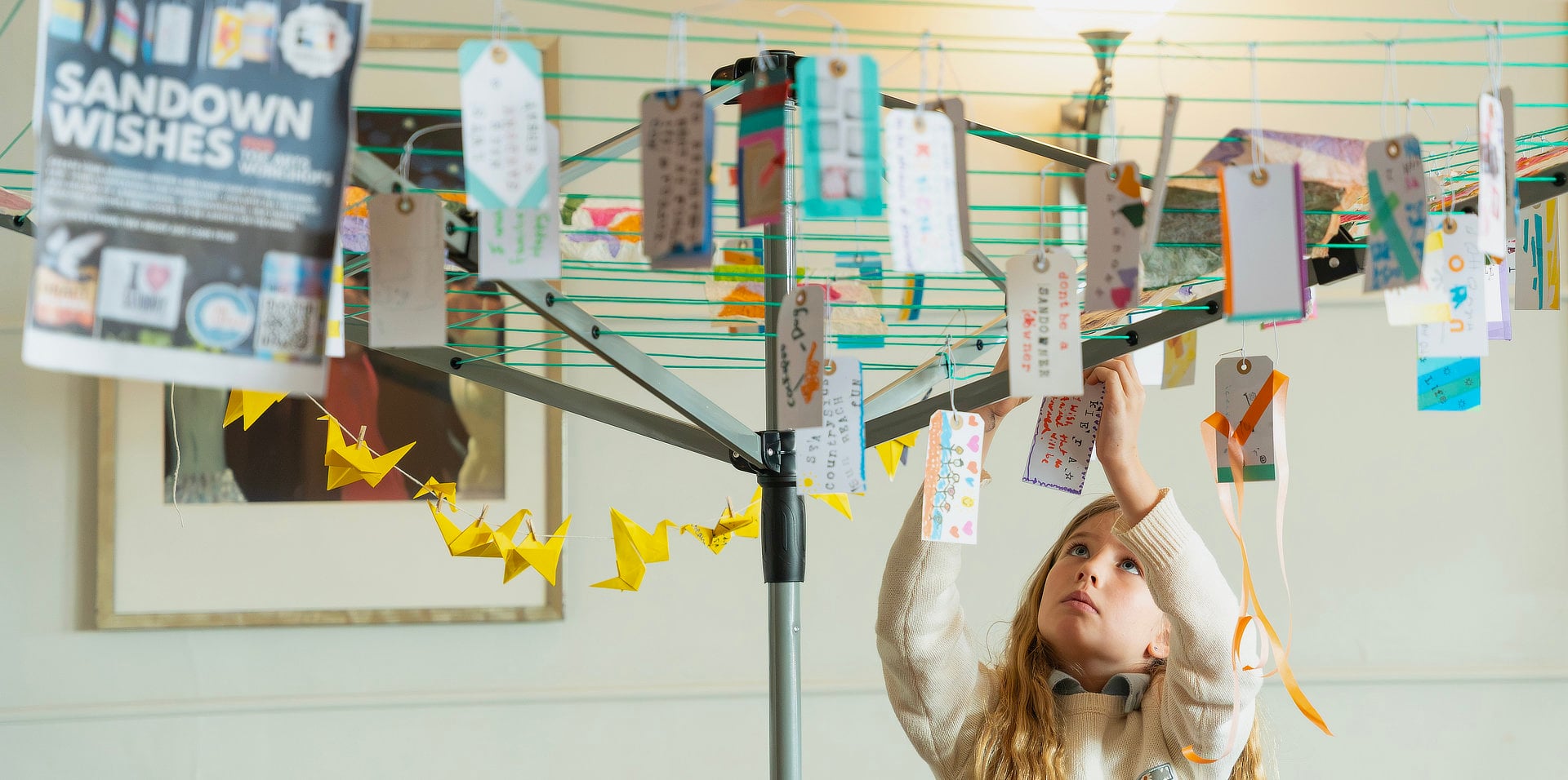 Messages of support for Sandown written on luggage labels hanging on a washing line