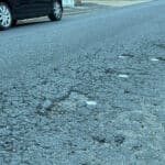 The pitted road surface on Tennyson Road