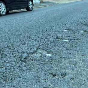 The pitted road surface on Tennyson Road