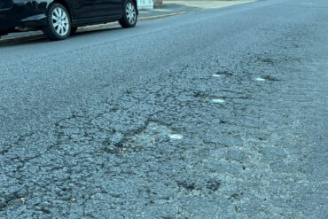 The pitted road surface on Tennyson Road