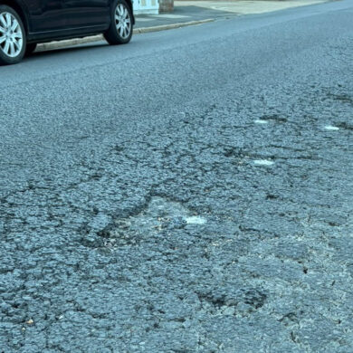 The pitted road surface on Tennyson Road