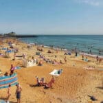 Ventnor beach during the summer with lots of people sunbathing and swimming