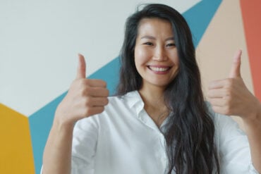 Woman holding her thumbs up