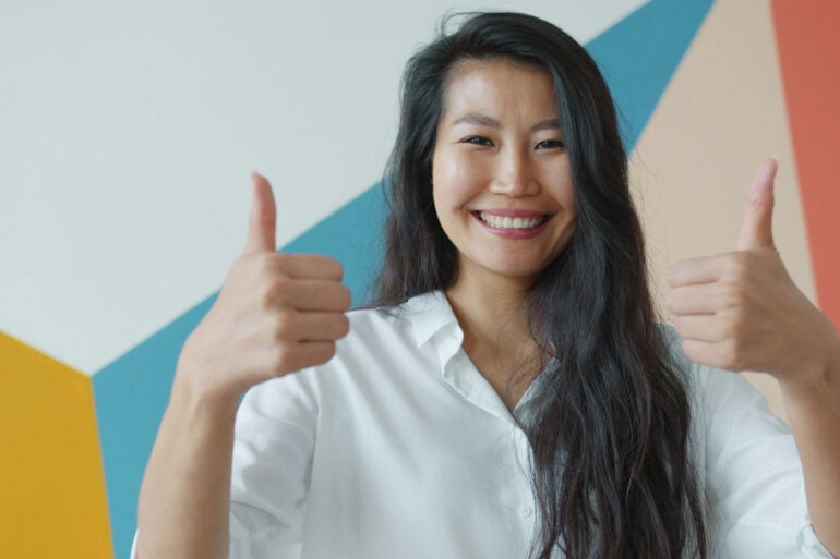 Woman holding her thumbs up
