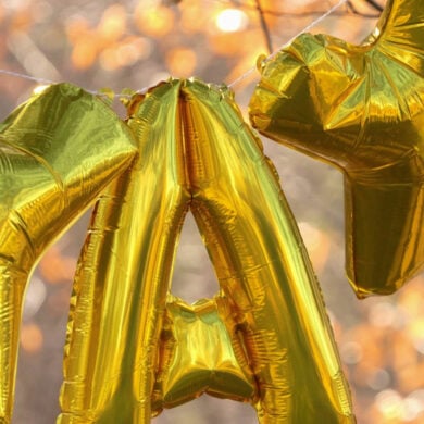 gold letter balloons spelling YAY