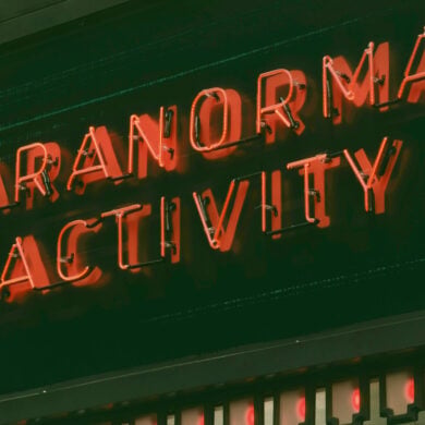 neon sign reading paranormal activity