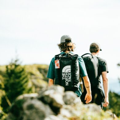two men trekking on a hillside